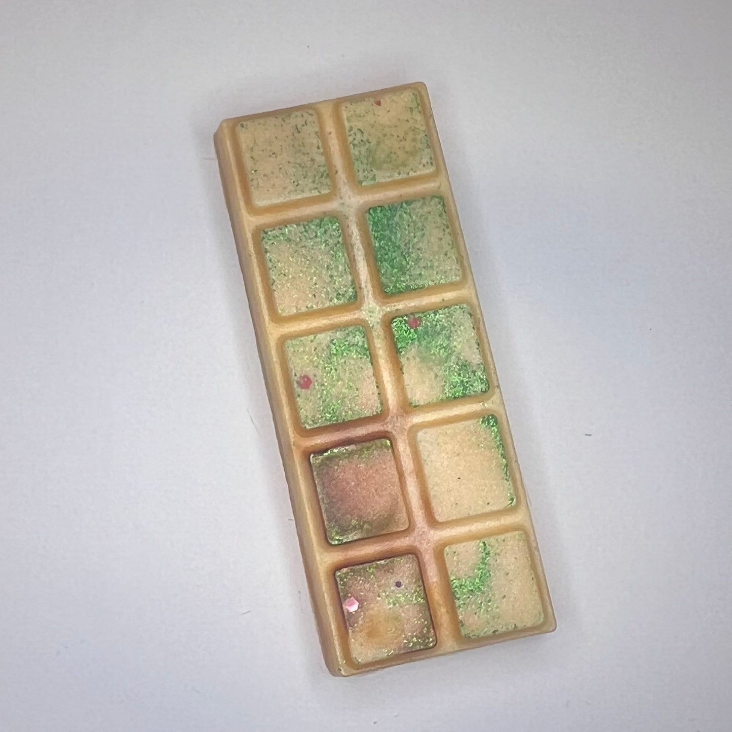 Oransje duftvoks/smeltevoks med grønt glitter