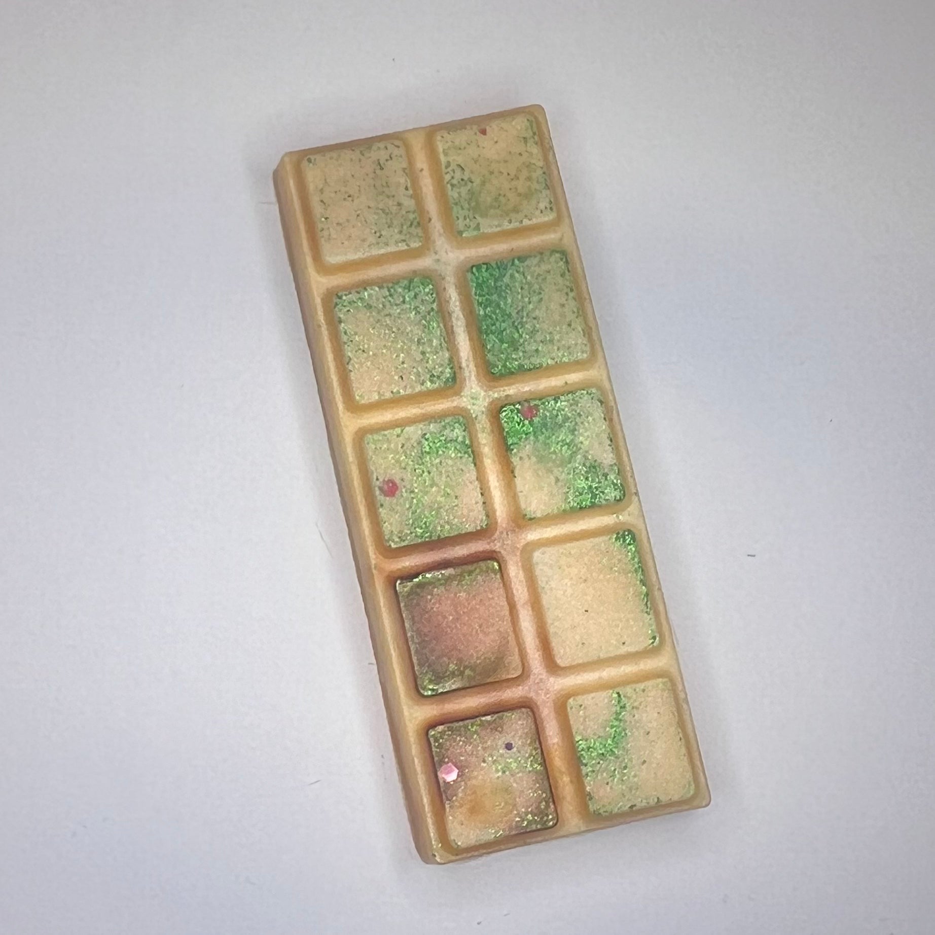 Oransje duftvoks/smeltevoks med grønt glitter