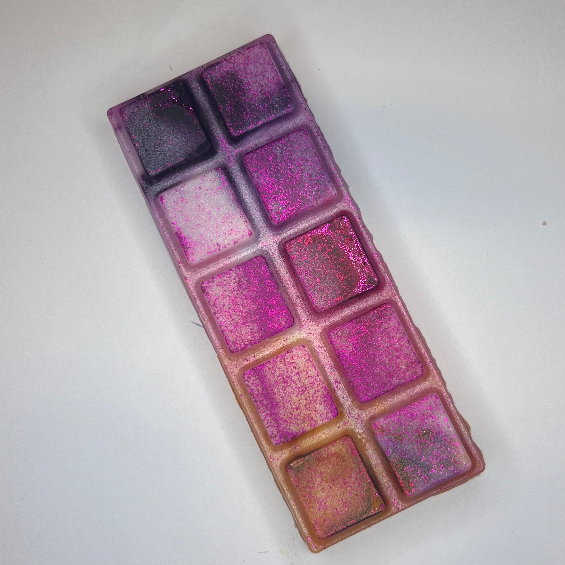 Lilla, rosa og oransje duftvoks med rosa glitter